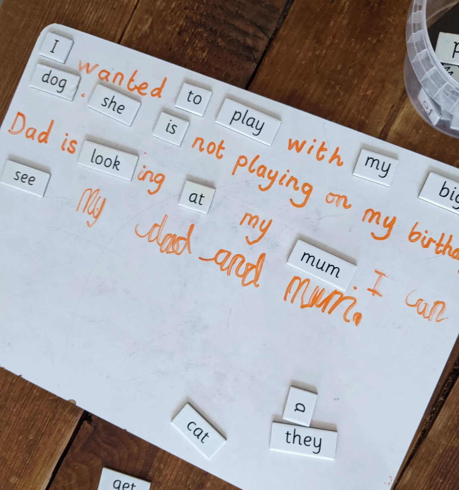 A sentence about a birthday built from word cards and finished in handwriting